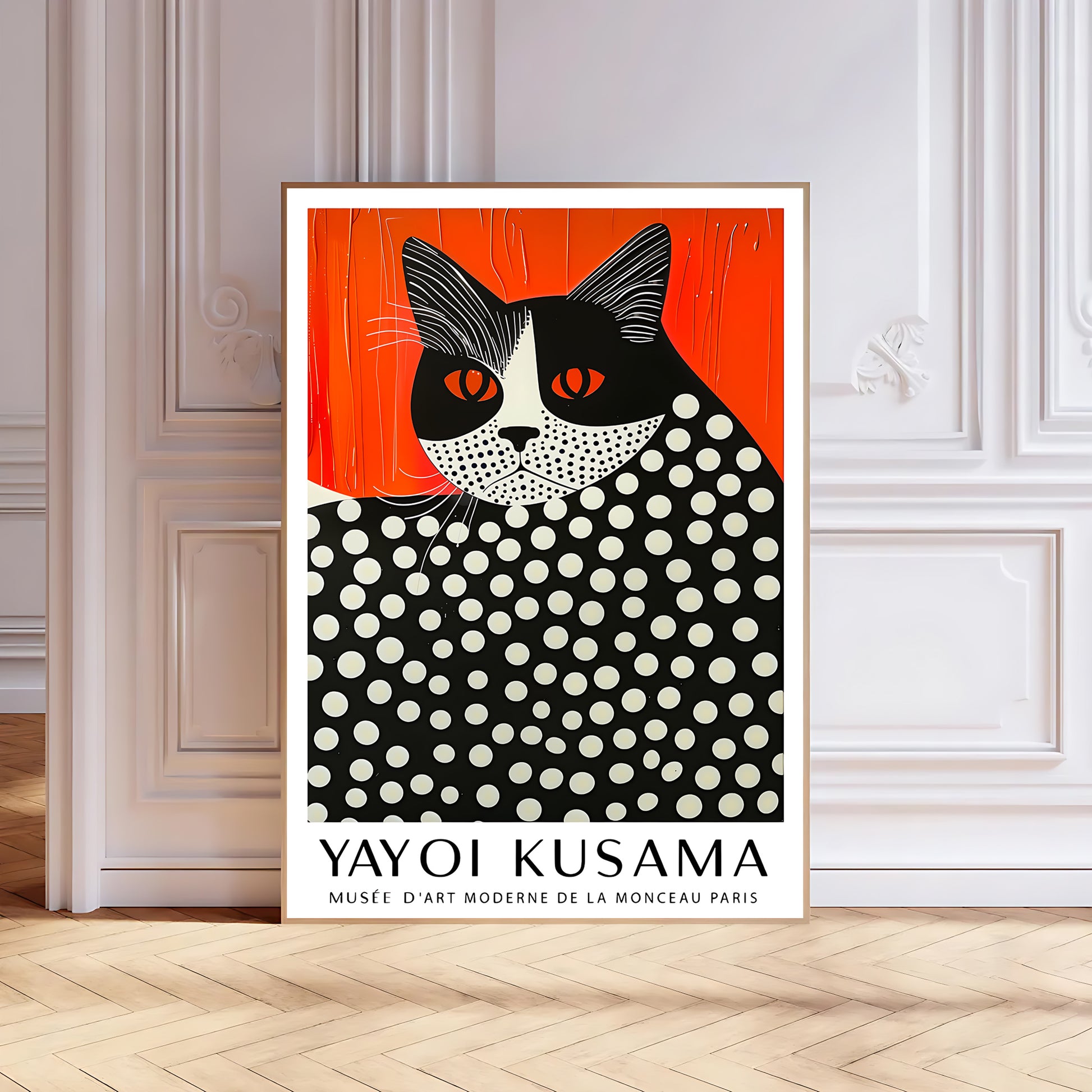 Contemporary black-framed Yayoi Kusama-inspired cat print with red-orange backdrop and dotted pattern, standing against a light grey wall on wooden flooring