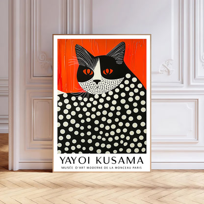 Contemporary black-framed Yayoi Kusama-inspired cat print with red-orange backdrop and dotted pattern, standing against a light grey wall on wooden flooring
