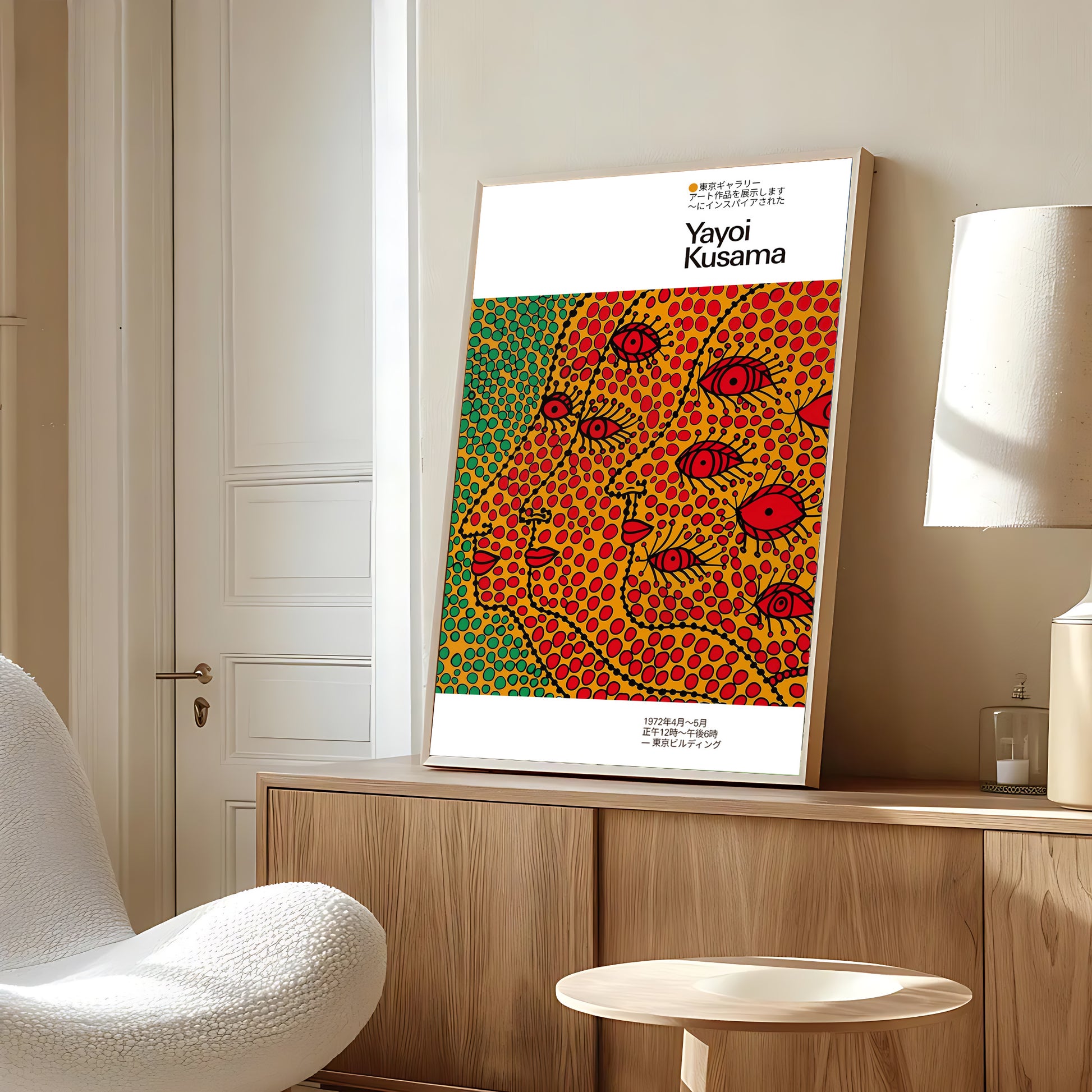 Colorful abstract faces wall art with bold polka dots and surreal red eyes framed and displayed in a modern cozy living room.