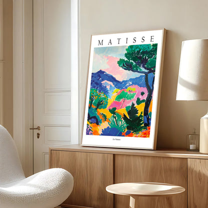 Framed Matisse artwork on a wall in a room with a chair and lamp.