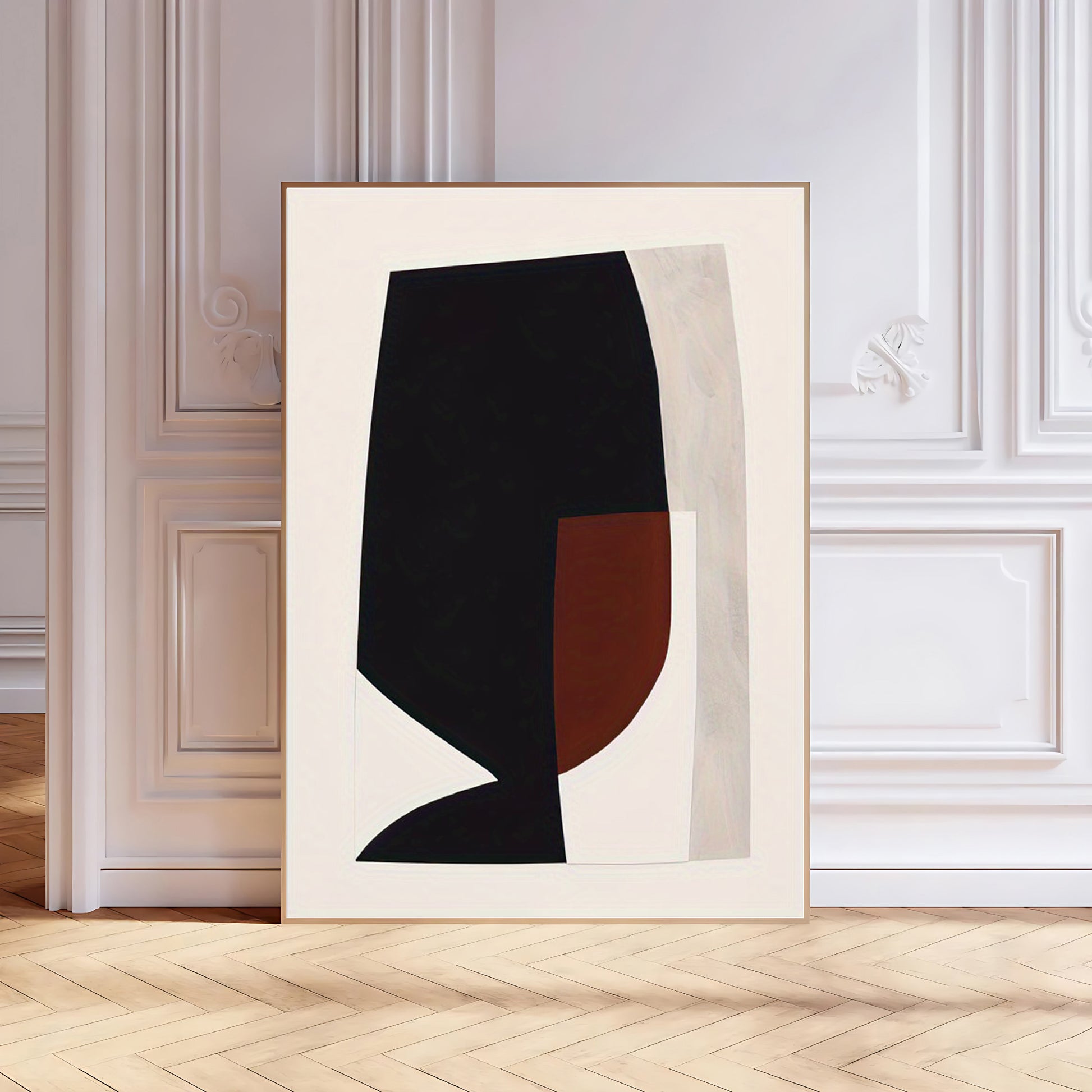 Abstract art print with black and brown shapes on a beige background, framed in a white frame.