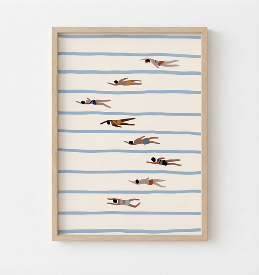 Framed wall art featuring a minimalist illustration of swimmers on horizontal blue stripes against a warm cream background, shown in a light wood frame on a white wall.