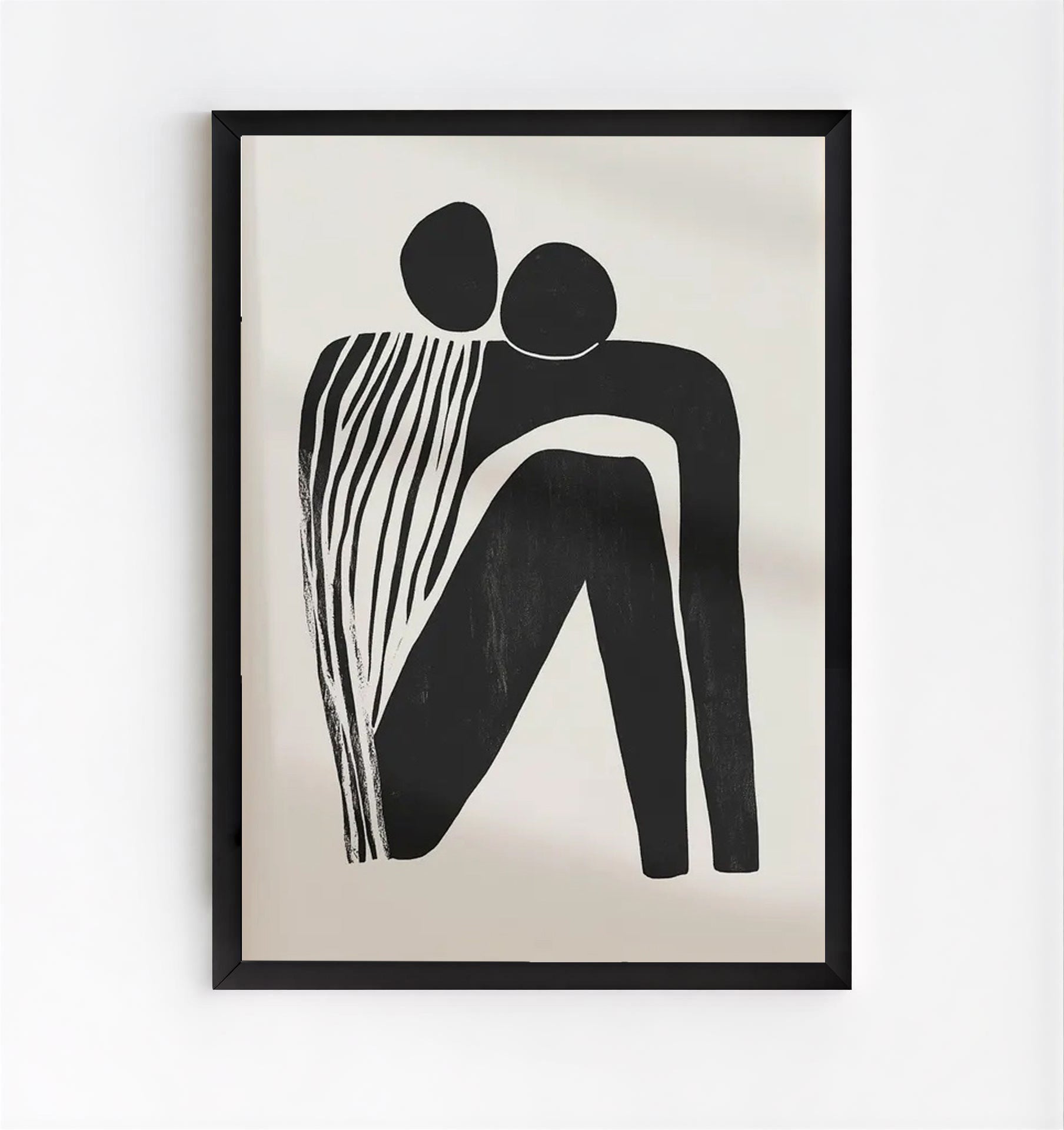 Framed black and white abstract artwork on a beige background