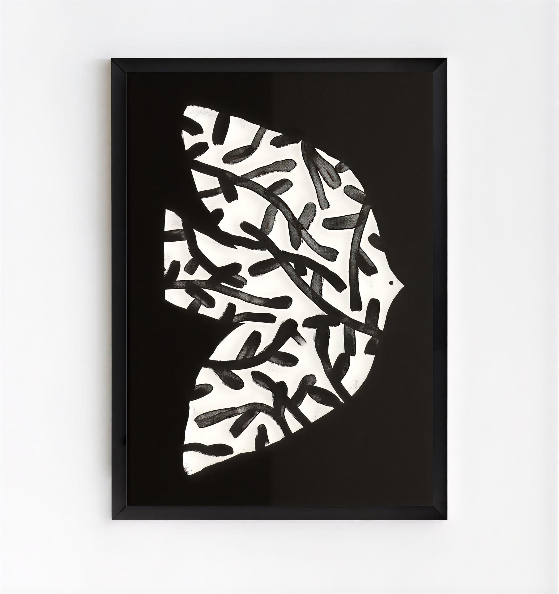 Framed abstract art piece with black and white pattern on a white background