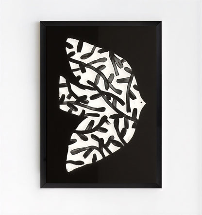 Framed abstract art piece with black and white pattern on a white background