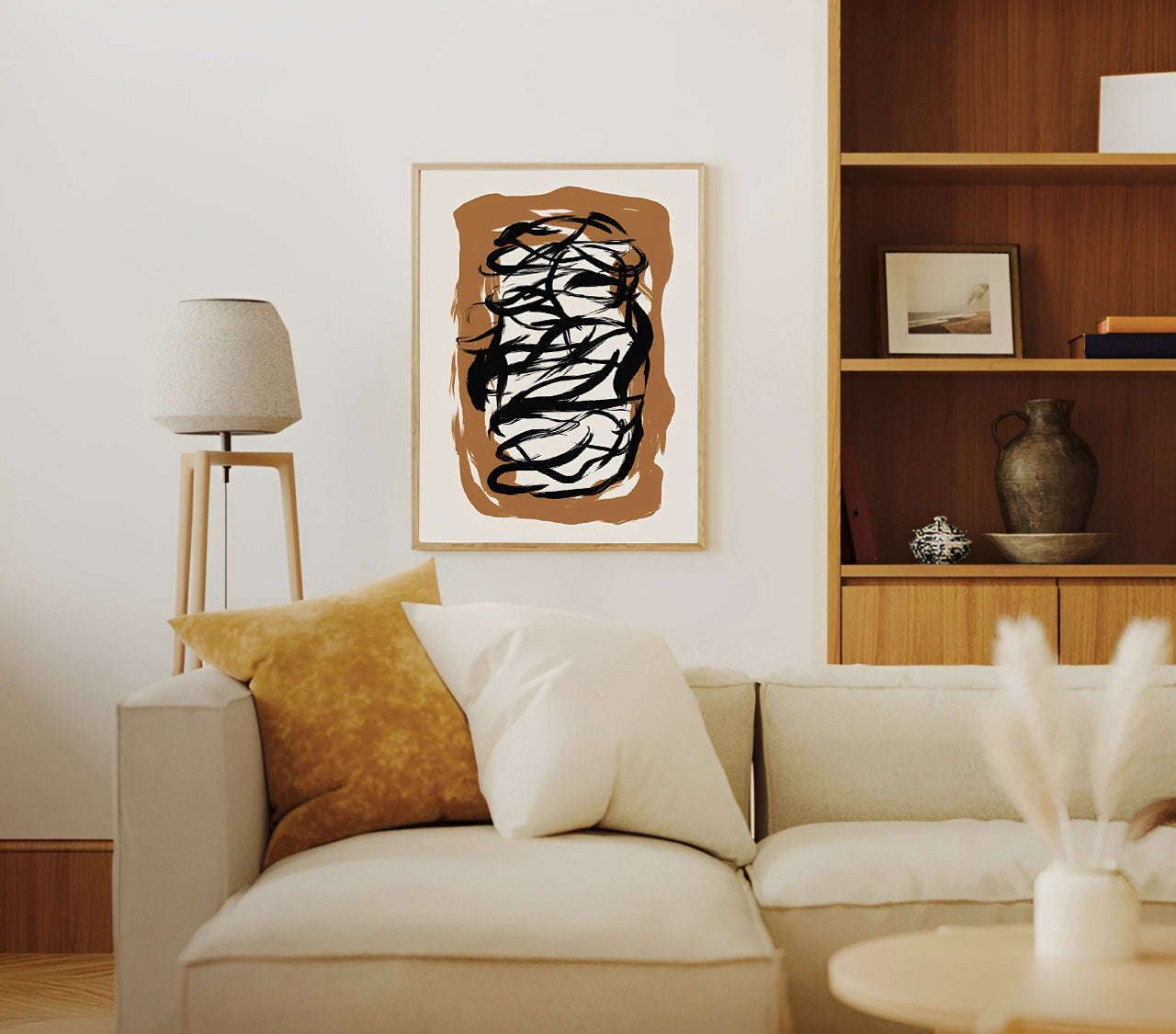 Living room with a beige sofa, abstract art on the wall, and wooden shelves.