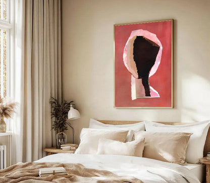 Neatly made bed with pillows and a decorative painting on the wall in a bedroom.