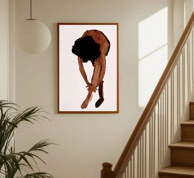 Framed artwork of a person with a black silhouette on a white background, hanging on a wall in a home setting.