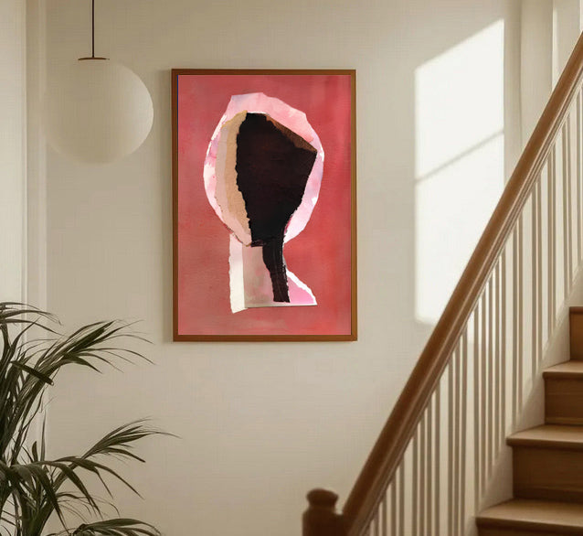 Framed abstract art piece on a wall next to a staircase