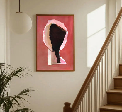 Framed abstract art piece on a wall next to a staircase