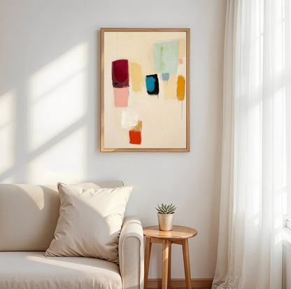 Living room with a beige sofa, small wooden table, and abstract art on the wall.