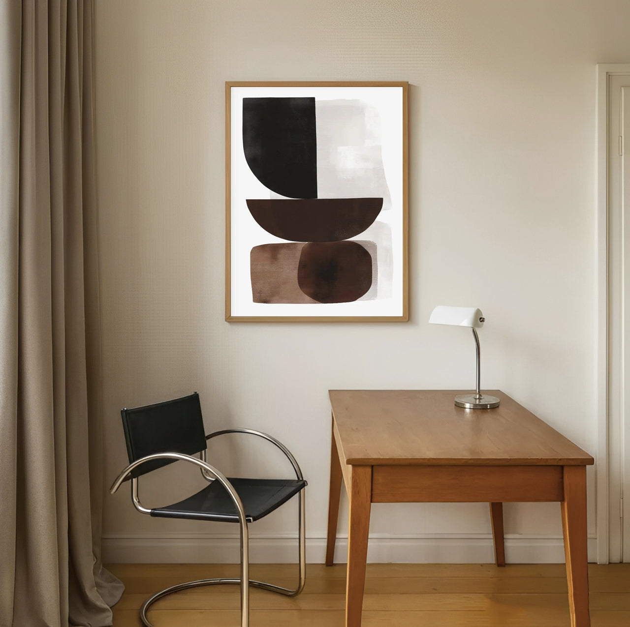 Modern interior with a wooden desk, black chair, and abstract art on the wall.