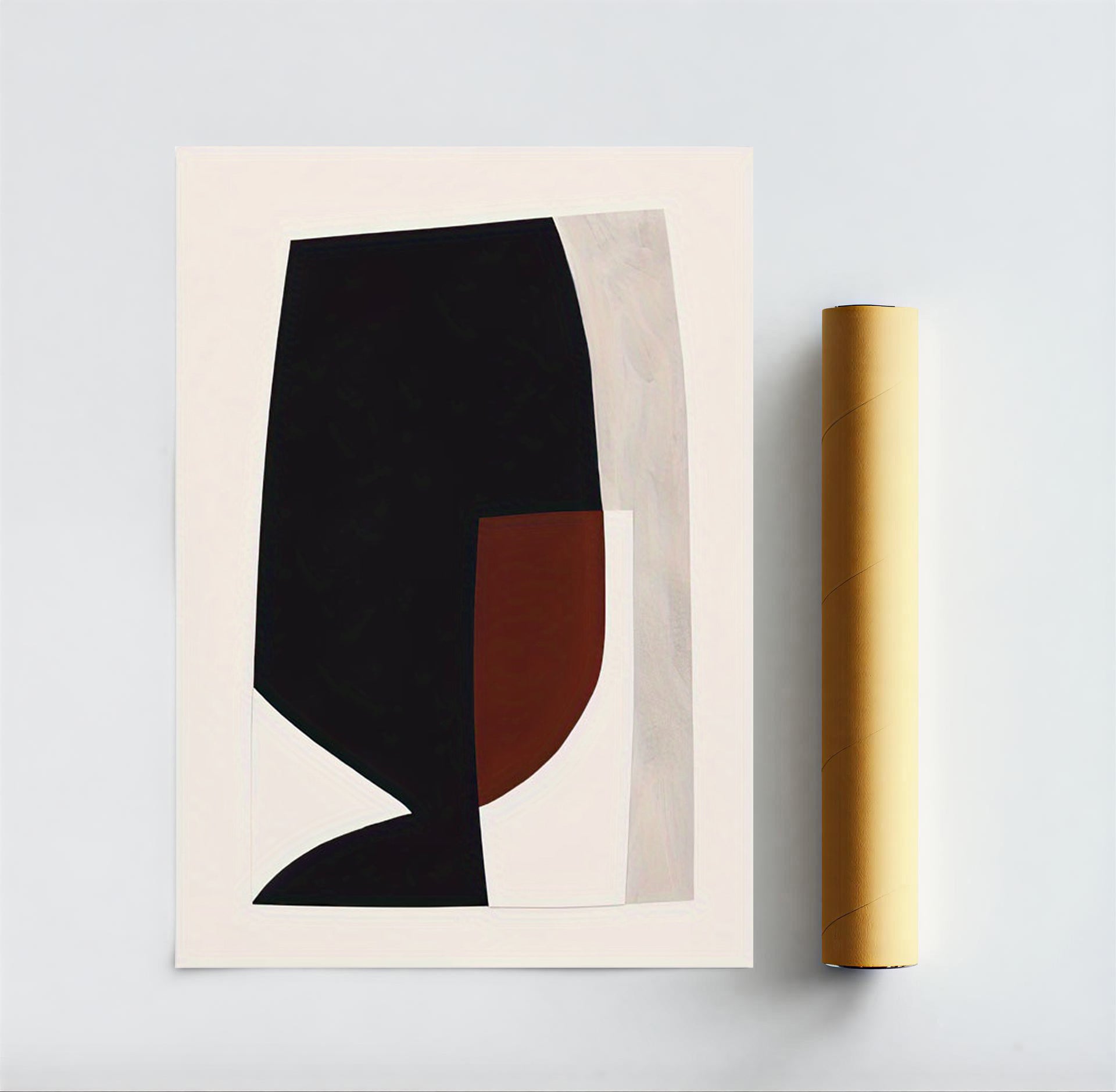 Abstract art print with black and brown shapes on a beige background, next to a yellow roll of paper.