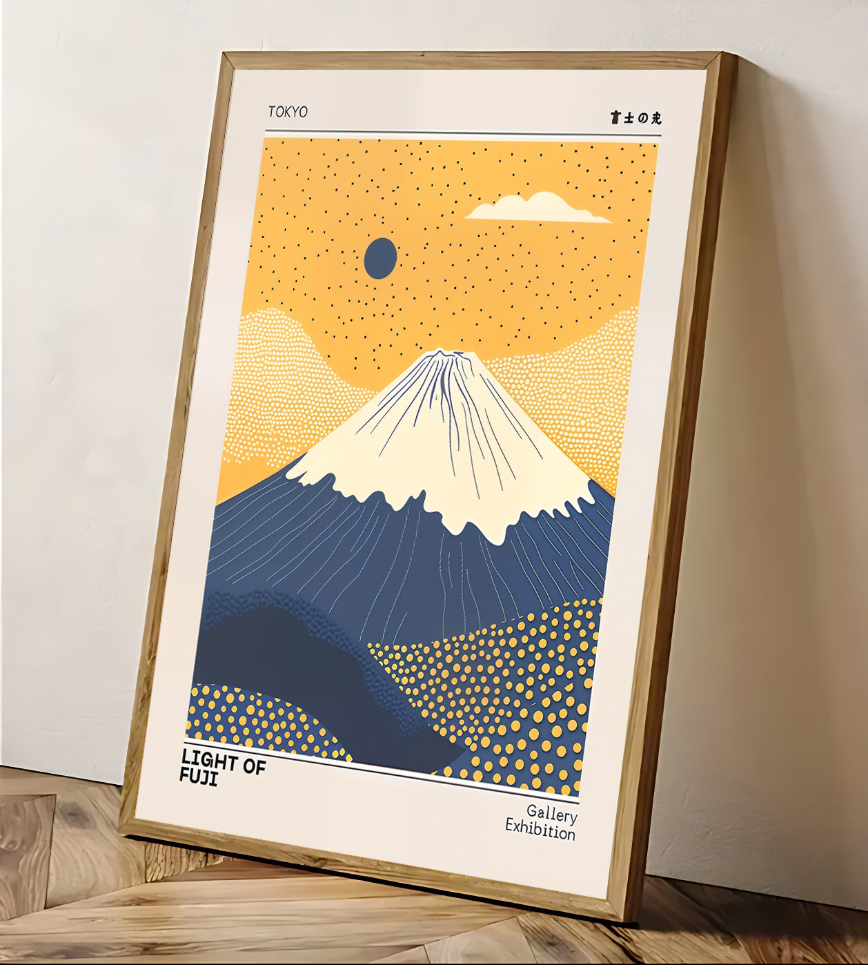 Framed artwork of Mount Fuji with a yellow sky and blue mountain, displayed on a wall.