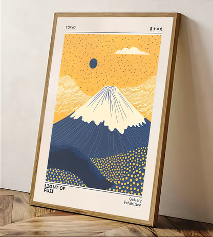 Framed artwork of Mount Fuji with a yellow sky and blue mountain, displayed on a wall.