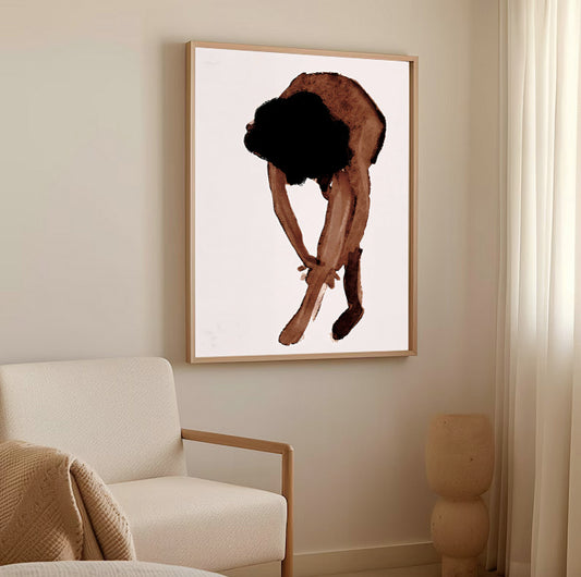 Framed artwork of a person tying their shoes on a wall in a living room.
