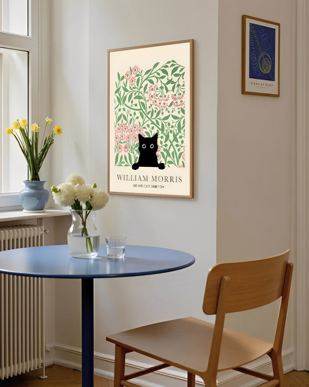 Dining room with a round table, wooden chair, and framed artwork on the wall.