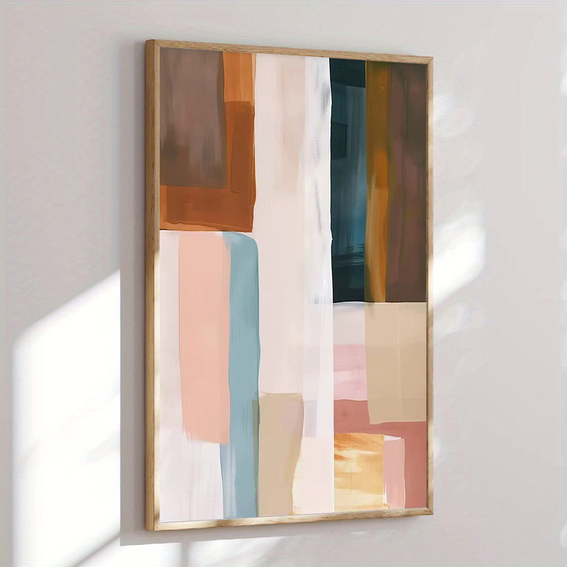 Abstract art piece with colorful geometric shapes in a wooden frame on a white wall.
