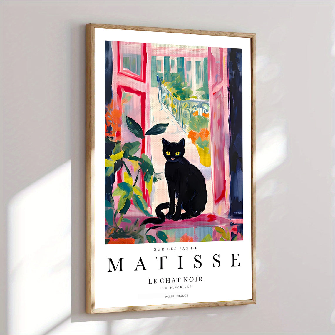 Framed black cat poster above modern interior table