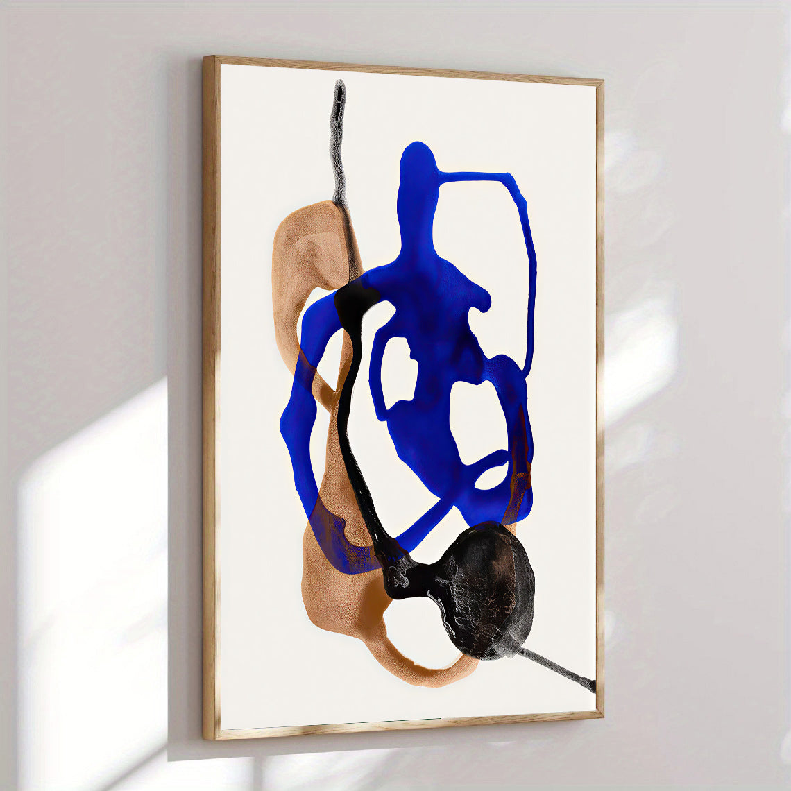 Modern abstract wall art print blue and neutral shapes on a white background, framed in gold.