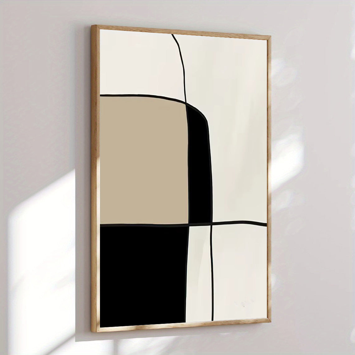 Abstract art piece with geometric shapes in a wooden frame on a white wall