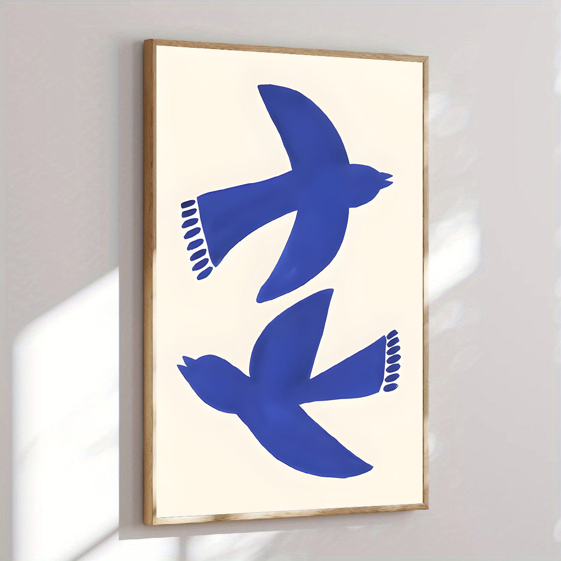 Framed artwork with blue bird silhouettes on a white background