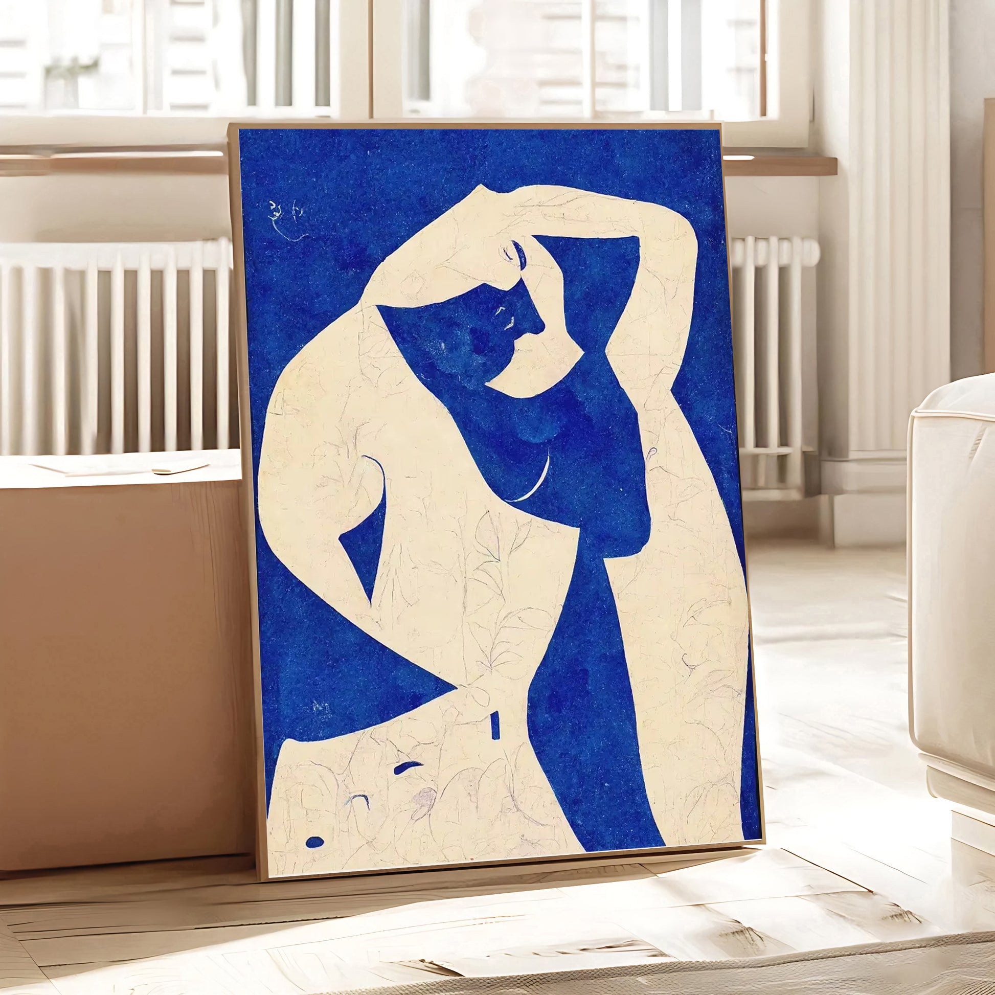 Framed abstract artwork of a nude figure with blue and white colors on a light background.