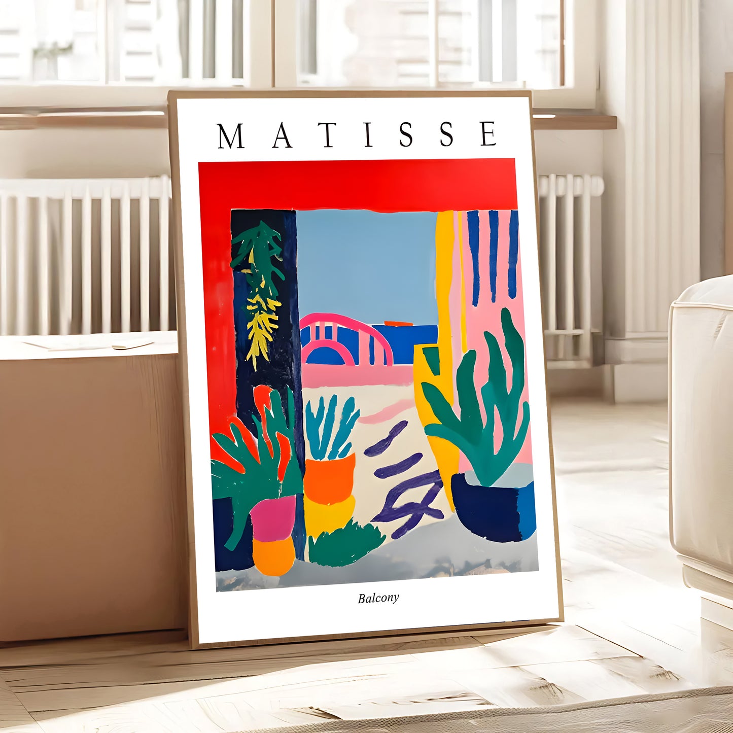 Framed Matisse artwork on a table in a room with light-colored walls and furniture.