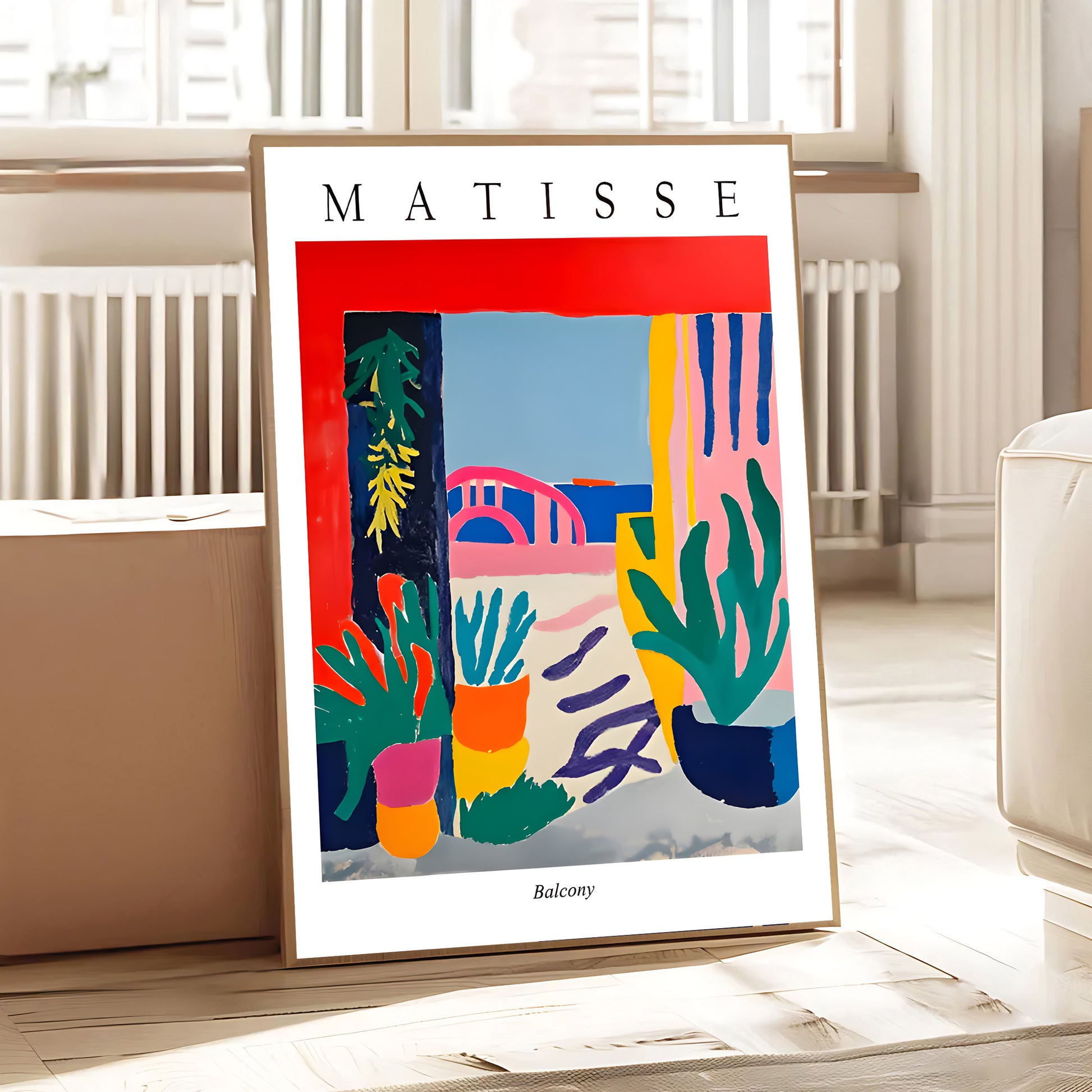 Framed Matisse artwork on a table in a room with light-colored walls and furniture.