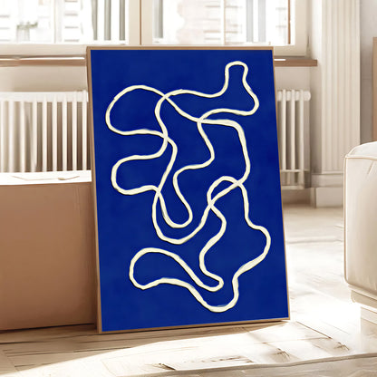 Abstract art piece with white lines on a blue background in a room setting.