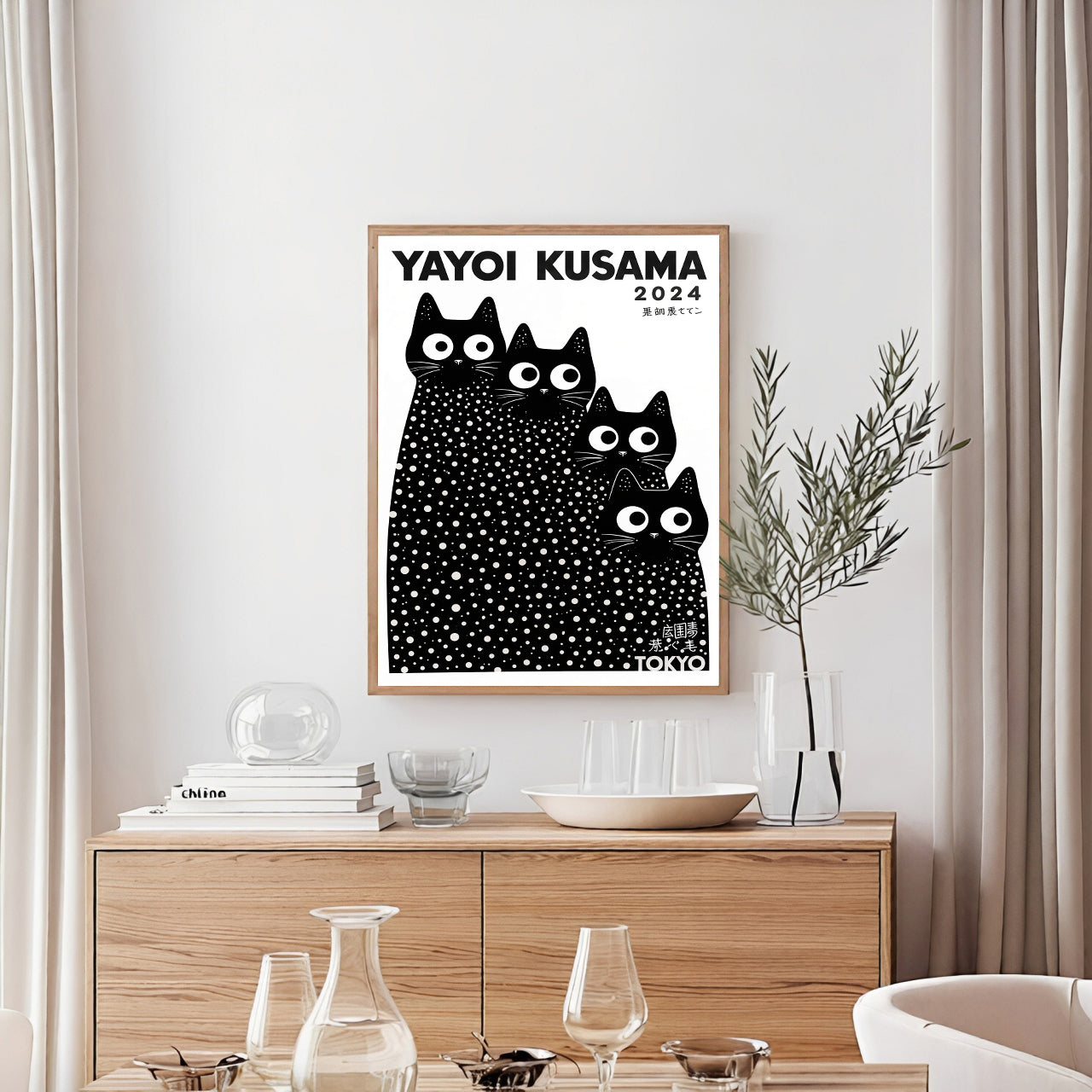 Framed Yayoi Kusama artwork with black cats in a modern interior setting.