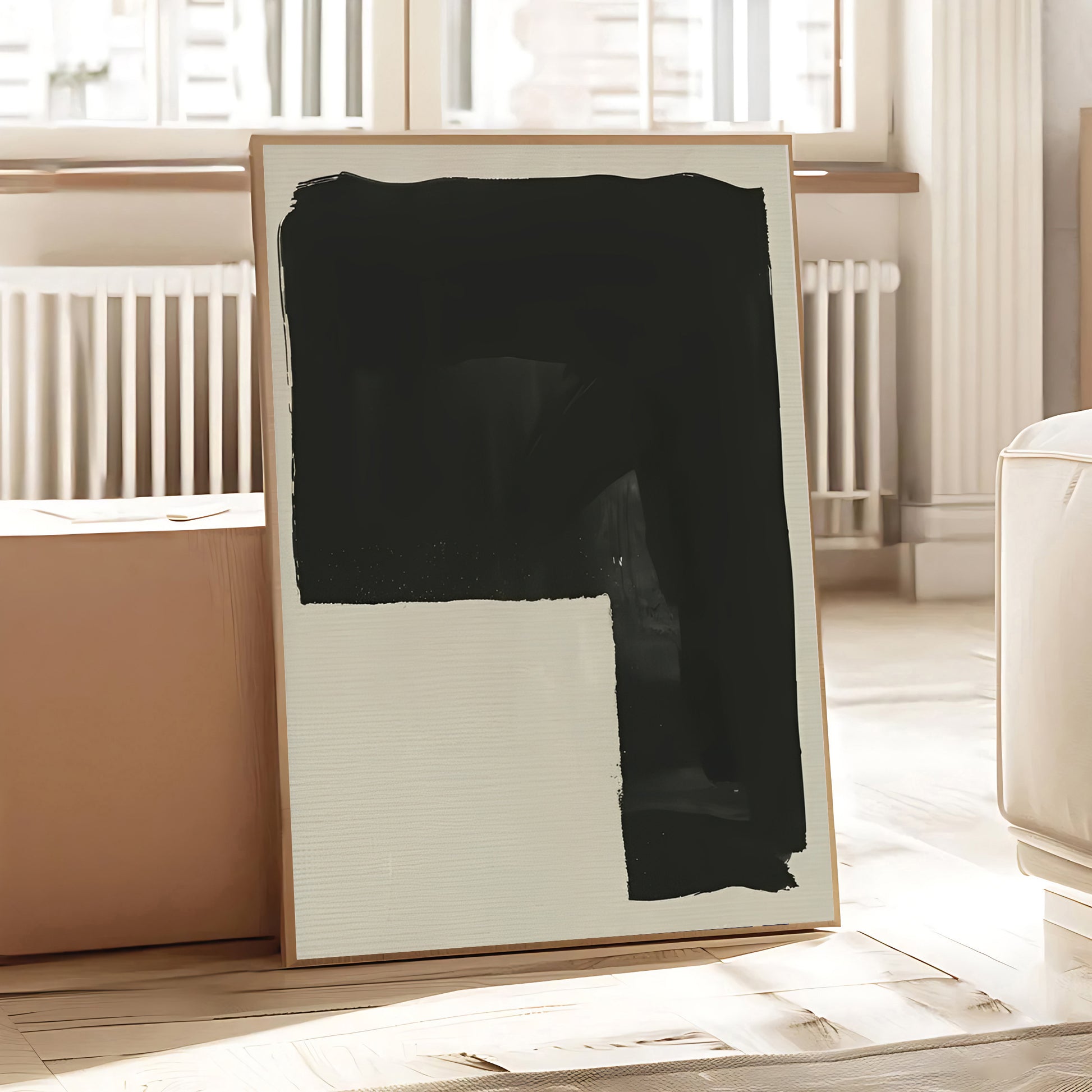 Abstract art piece with black and white colors on a wooden frame, placed indoors.