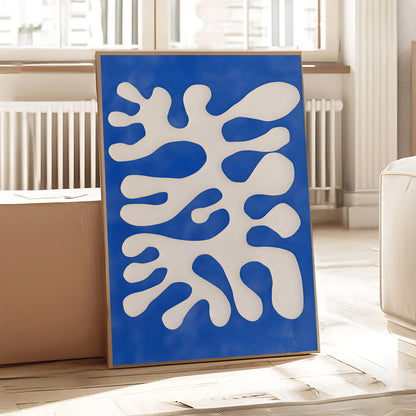 Abstract art piece with blue and white design on a wooden floor.