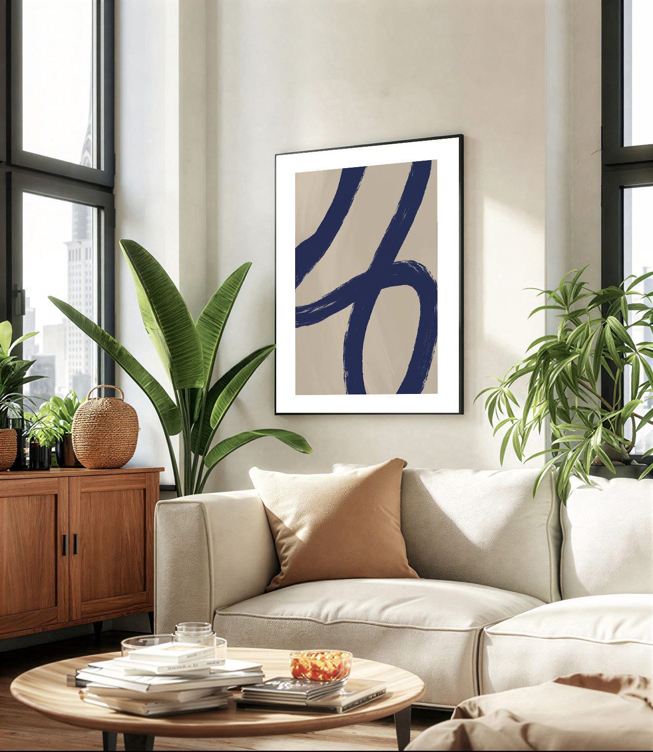Modern living room with a beige sofa, round wooden coffee table, and abstract art on the wall.