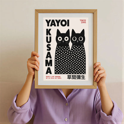 Framed artwork by Yayoi Kusama Inspired Black Cat Poster with white polka dots on a beige background.