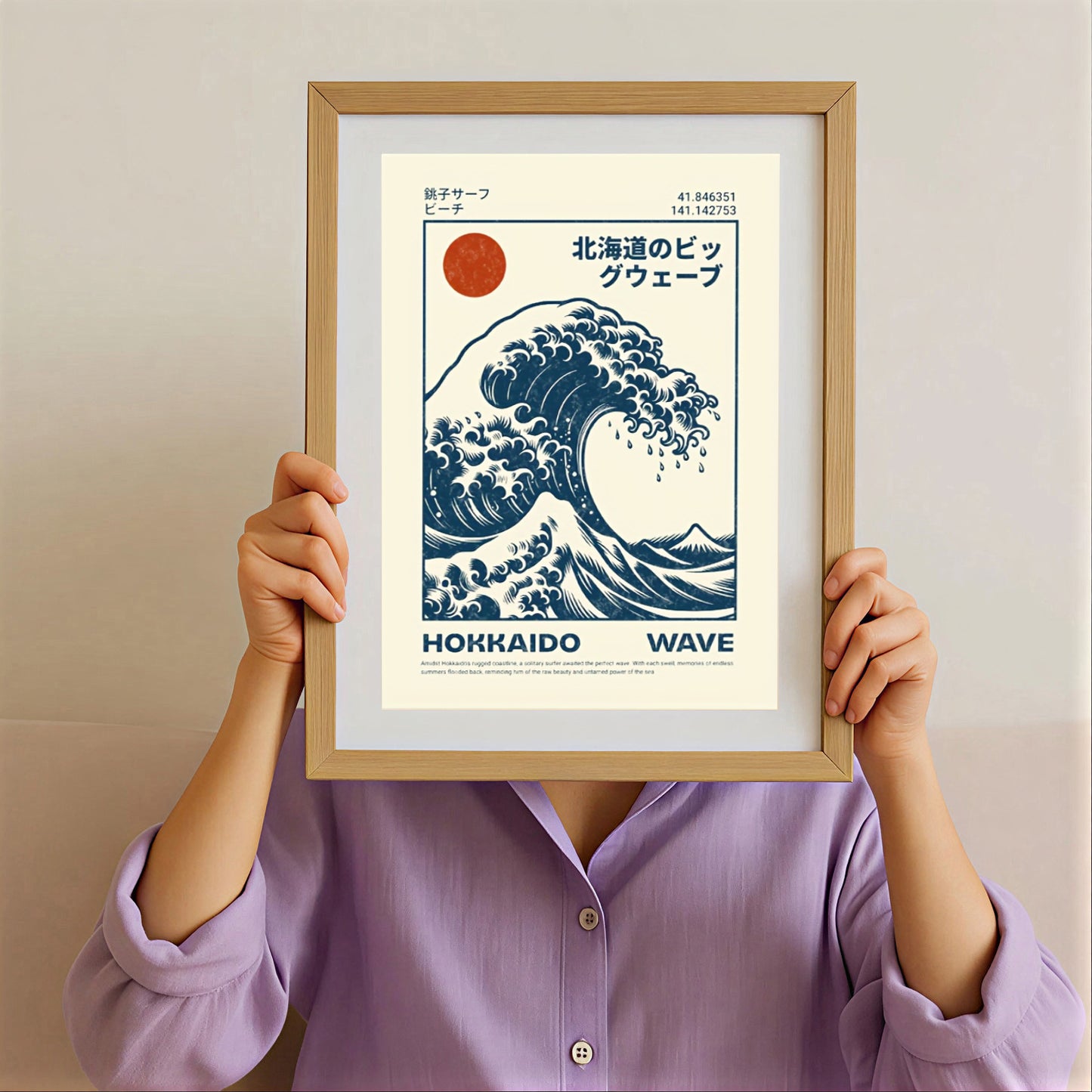 Framed poster of Hokusai Wave Poster Print held by a person wearing a purple shirt.