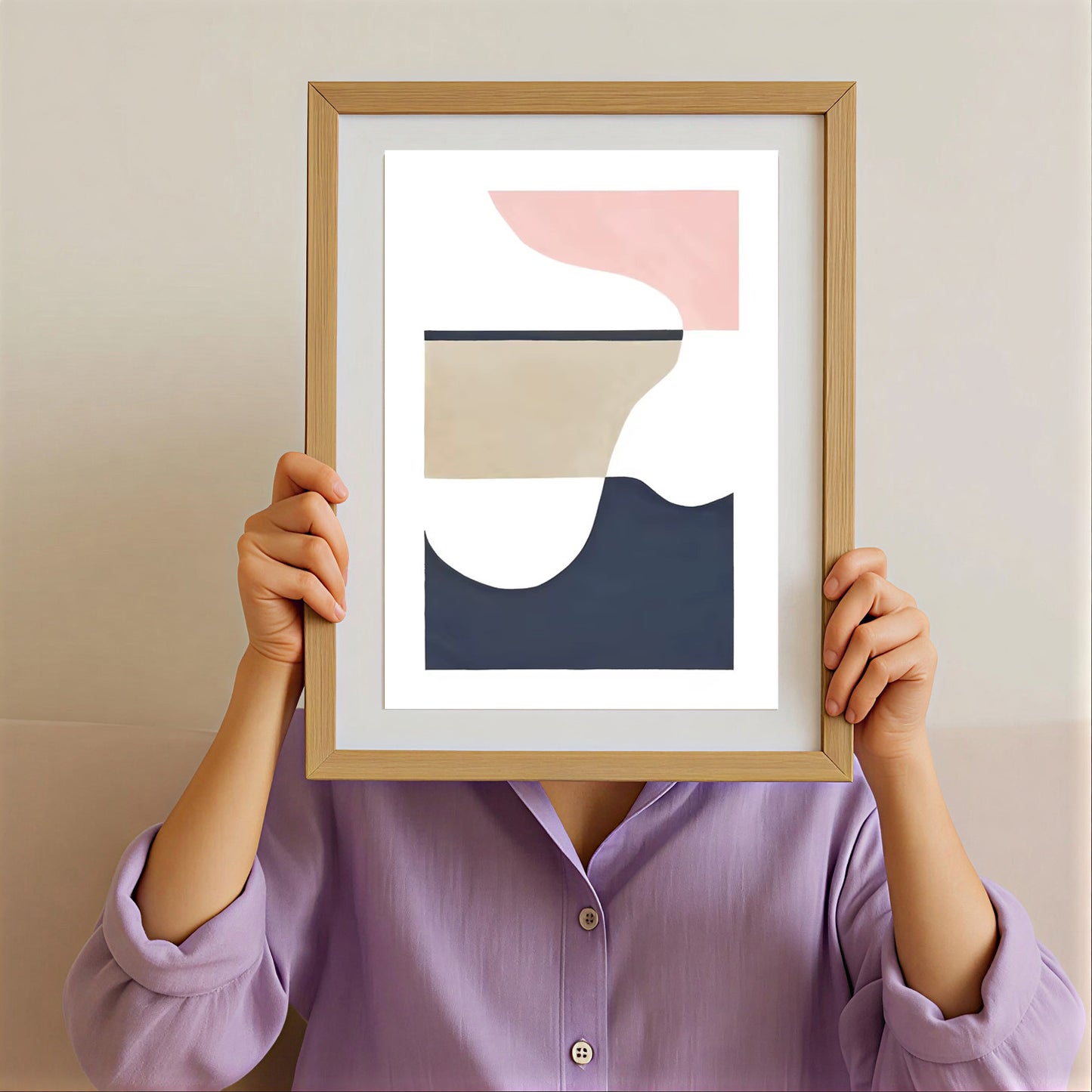 Person holding a framed abstract art print with a minimalistic design.