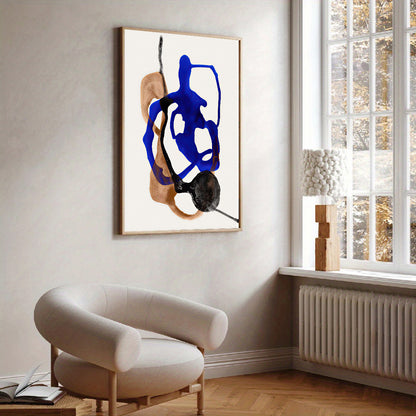 Abstract art piece on a wall in a modern living room with a chair and window.