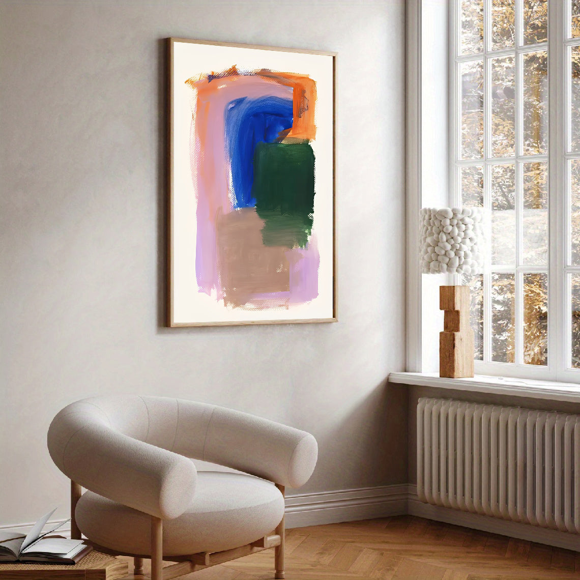 Modern living room with abstract art on the wall and a chair near a window.