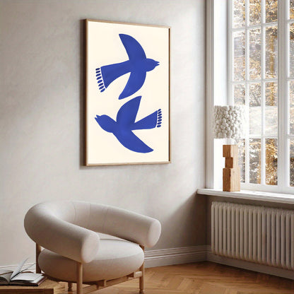 Framed artwork of blue birds on a white wall above a modern chair.