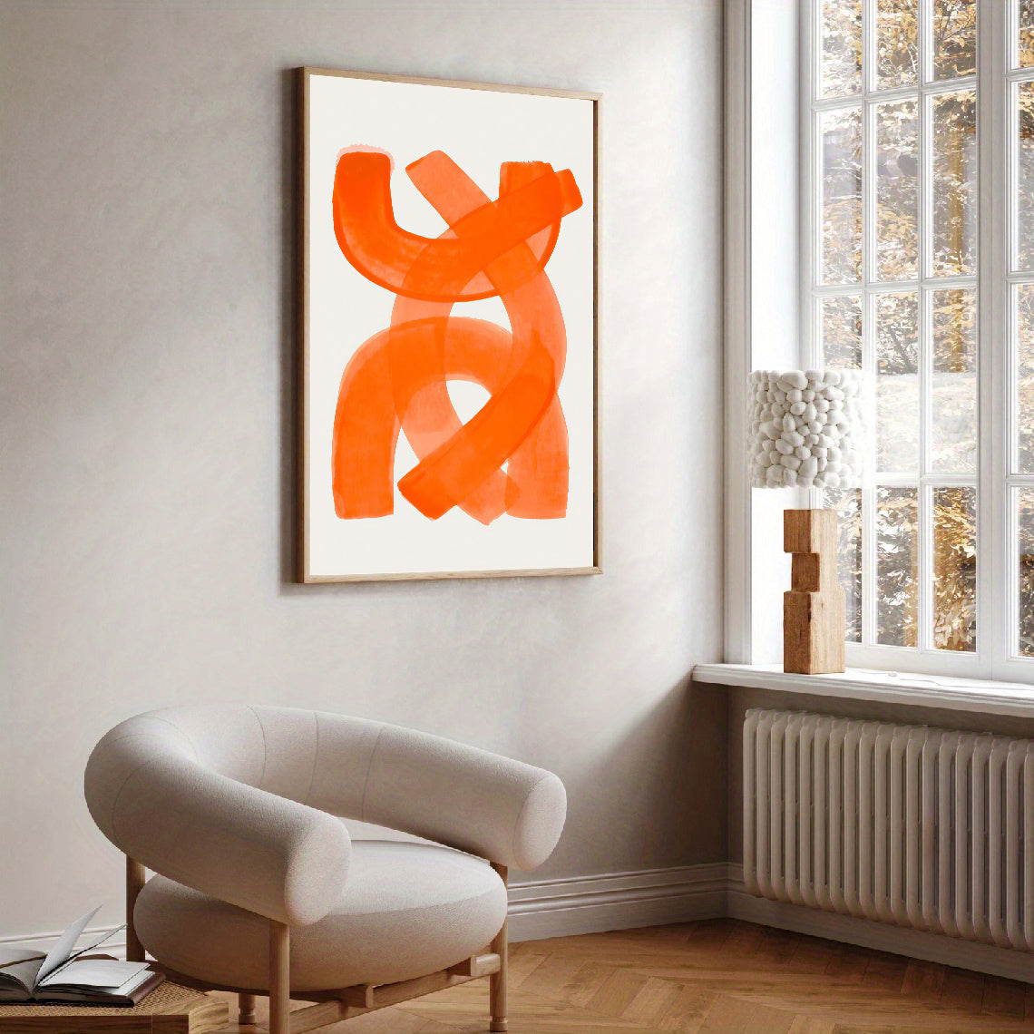 Modern living room with abstract orange artwork on the wall and a beige armchair.