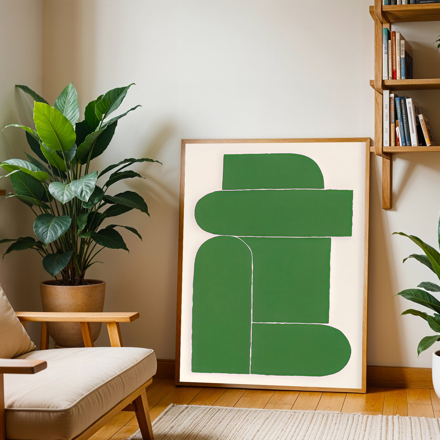 Green abstract art print in a wooden frame on a wall with plants and a bookshelf in the background.