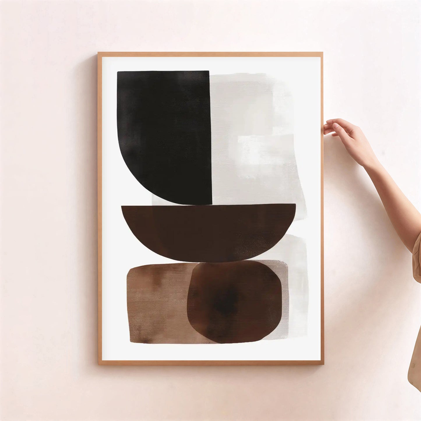 Framed abstract art piece with geometric shapes on a light pink wall.