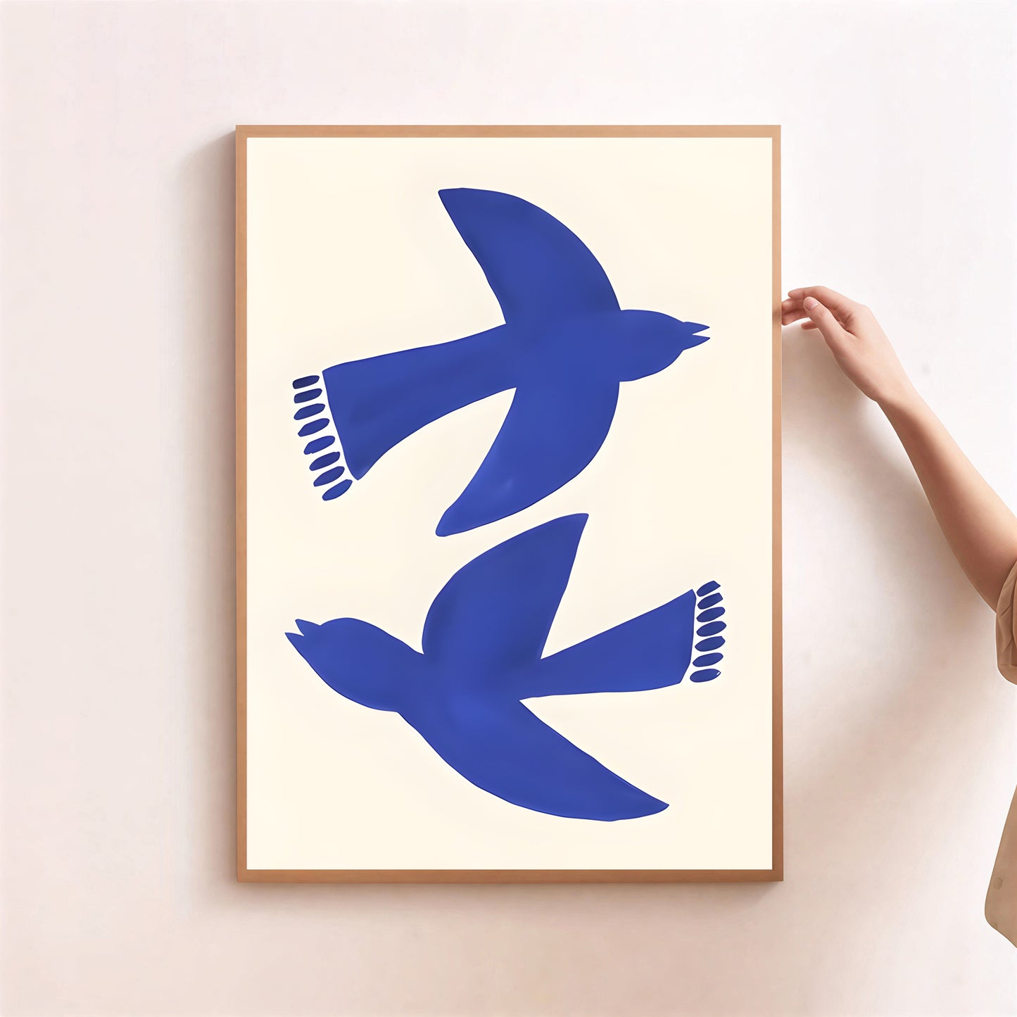 Framed artwork with blue bird silhouettes on a white background
