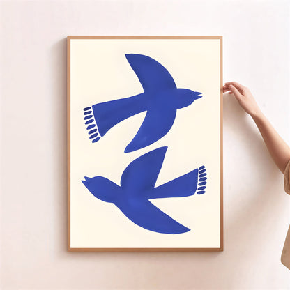 Framed artwork with blue bird silhouettes on a white background