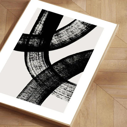 Abstract black and white artwork on a wooden floor