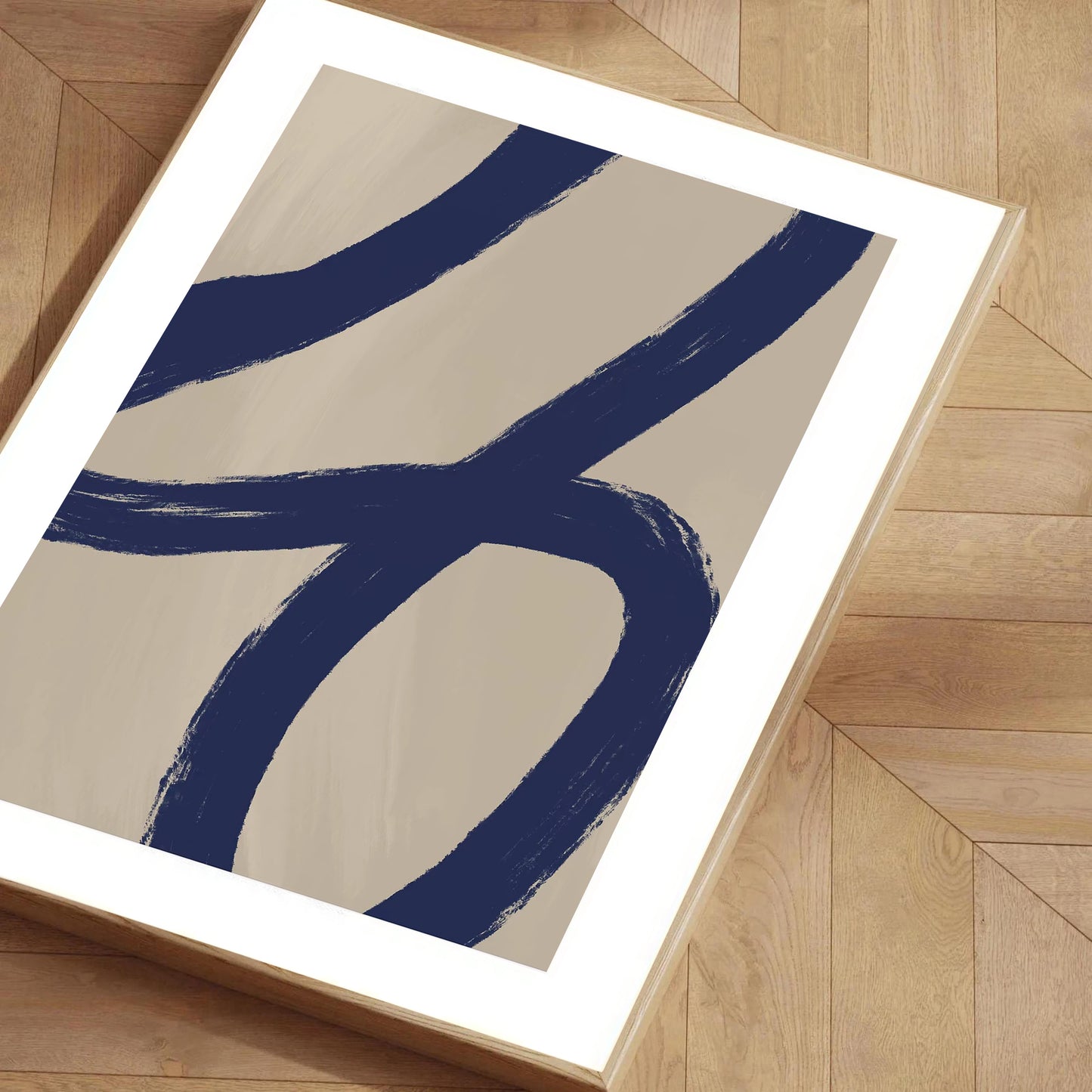 Abstract art print with blue and beige design on a wooden floor