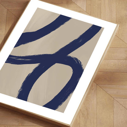 Abstract art print with blue and beige design on a wooden floor
