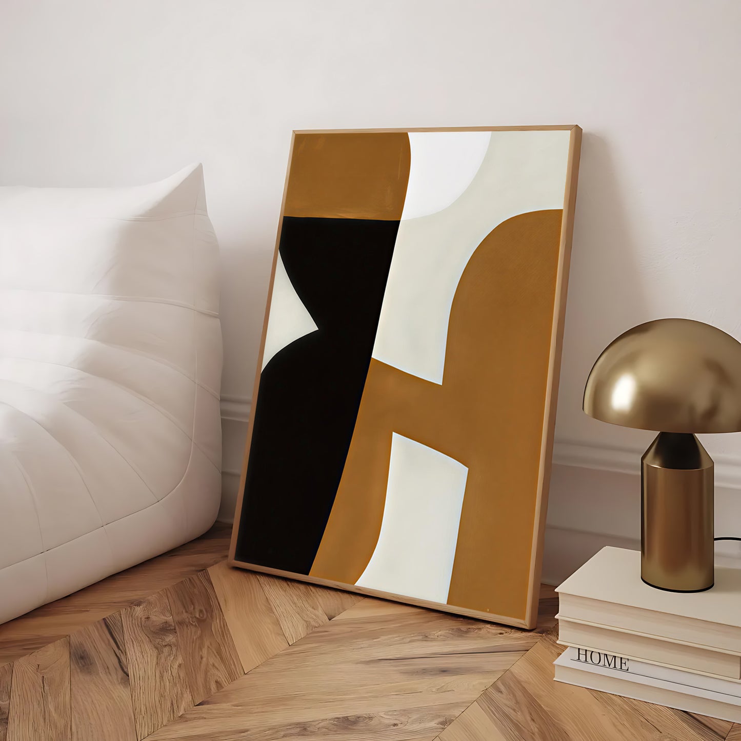 Abstract art piece with geometric design on a wooden floor, next to a lamp and books.