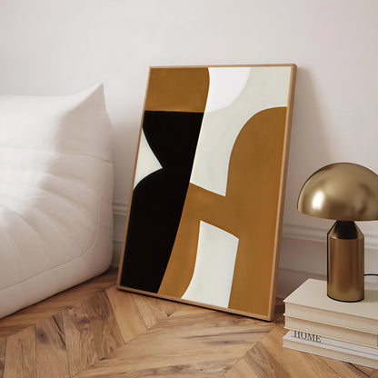 Abstract art piece with geometric design on a wooden floor, next to a lamp and books.